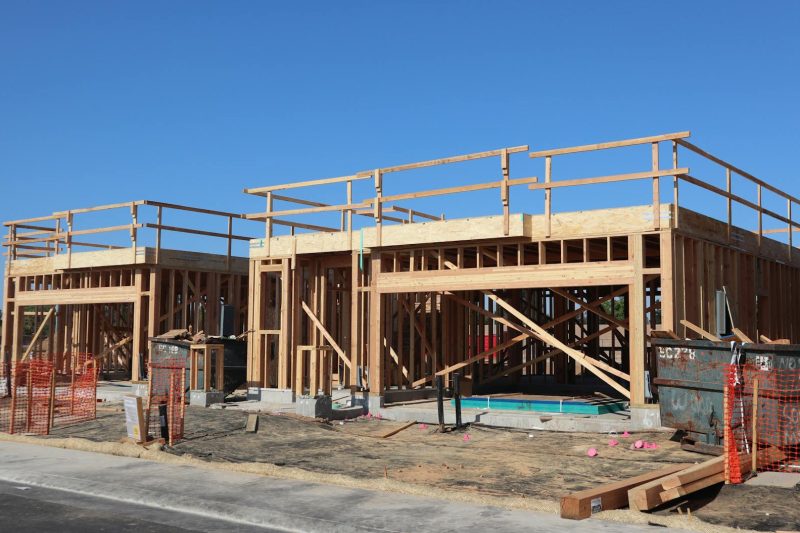 New residential construction featuring wooden framing in a suburban area of Elk Grove, California.